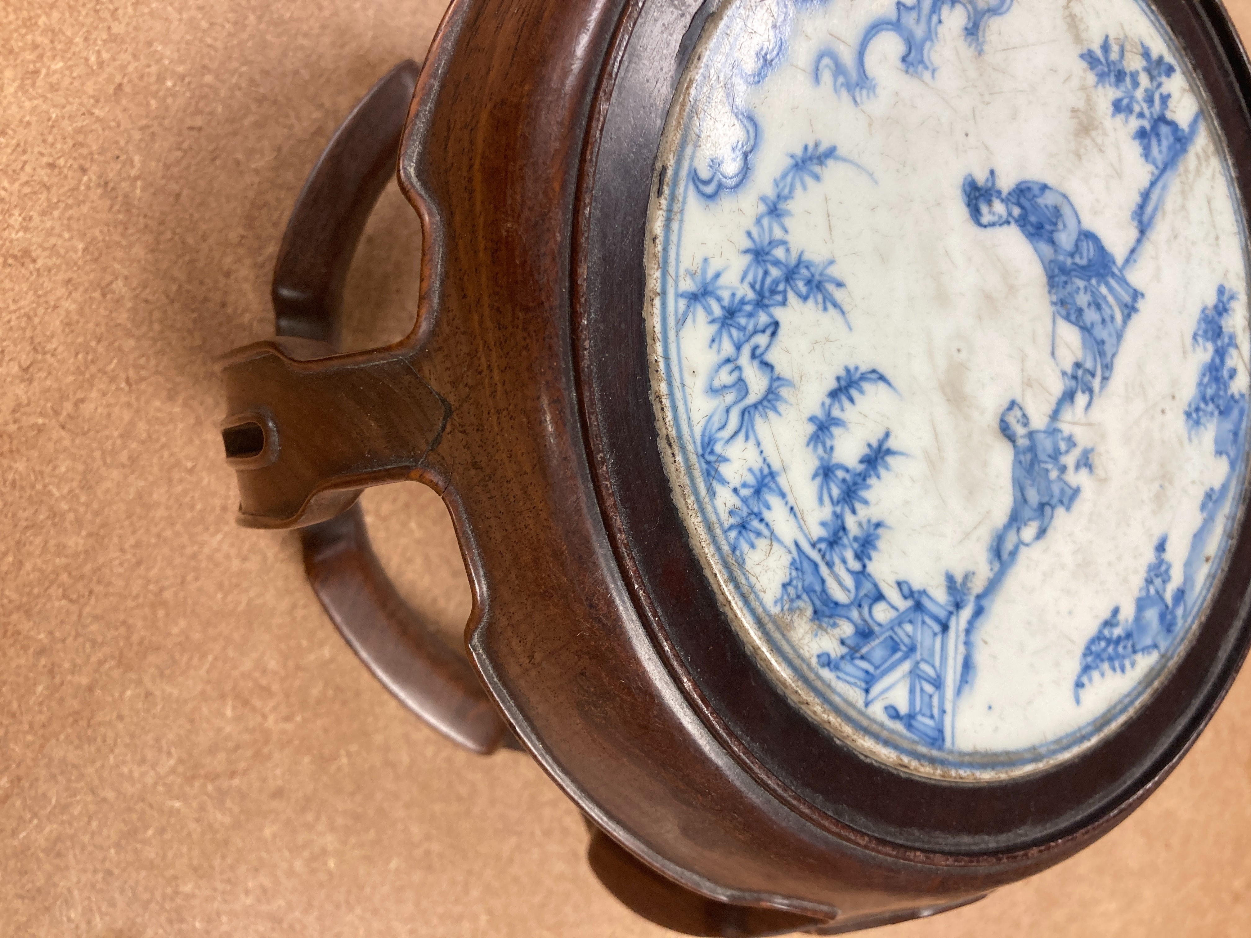 A 19th century Chinese blue and white circular tile inset hongmu stand, 22cm